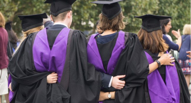 Students at graduation wearing caps and gowns