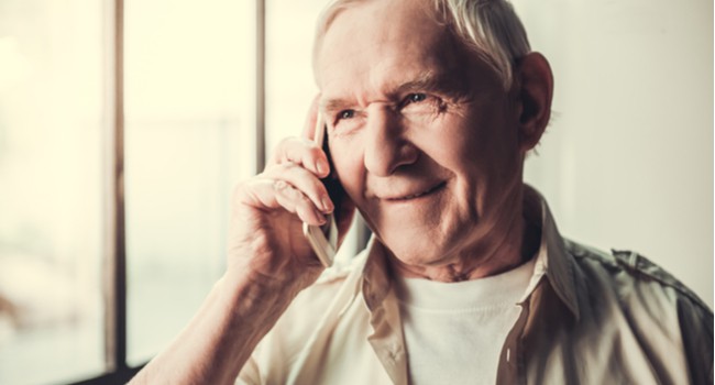 An older man speaking on a mobile phone
