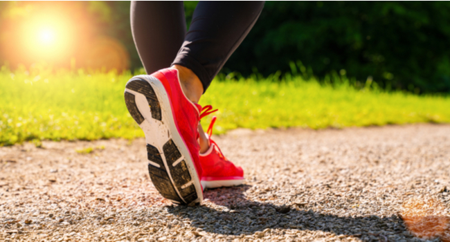 A person walking in running shoes in summer.