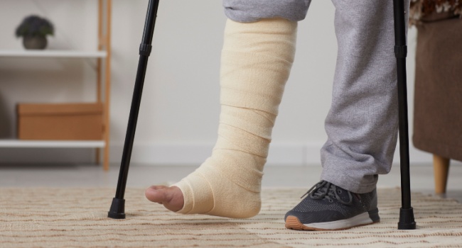 A man with a broken leg using crutches.